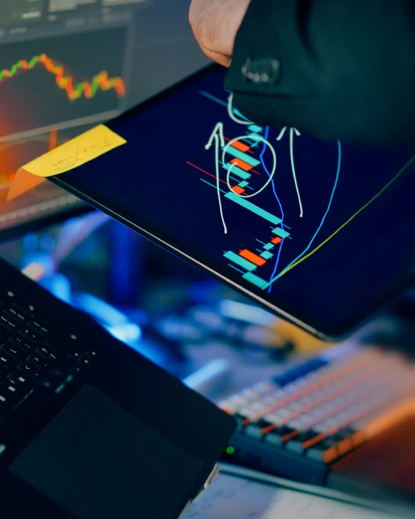 A trader analyzing stock market charts across multiple screens